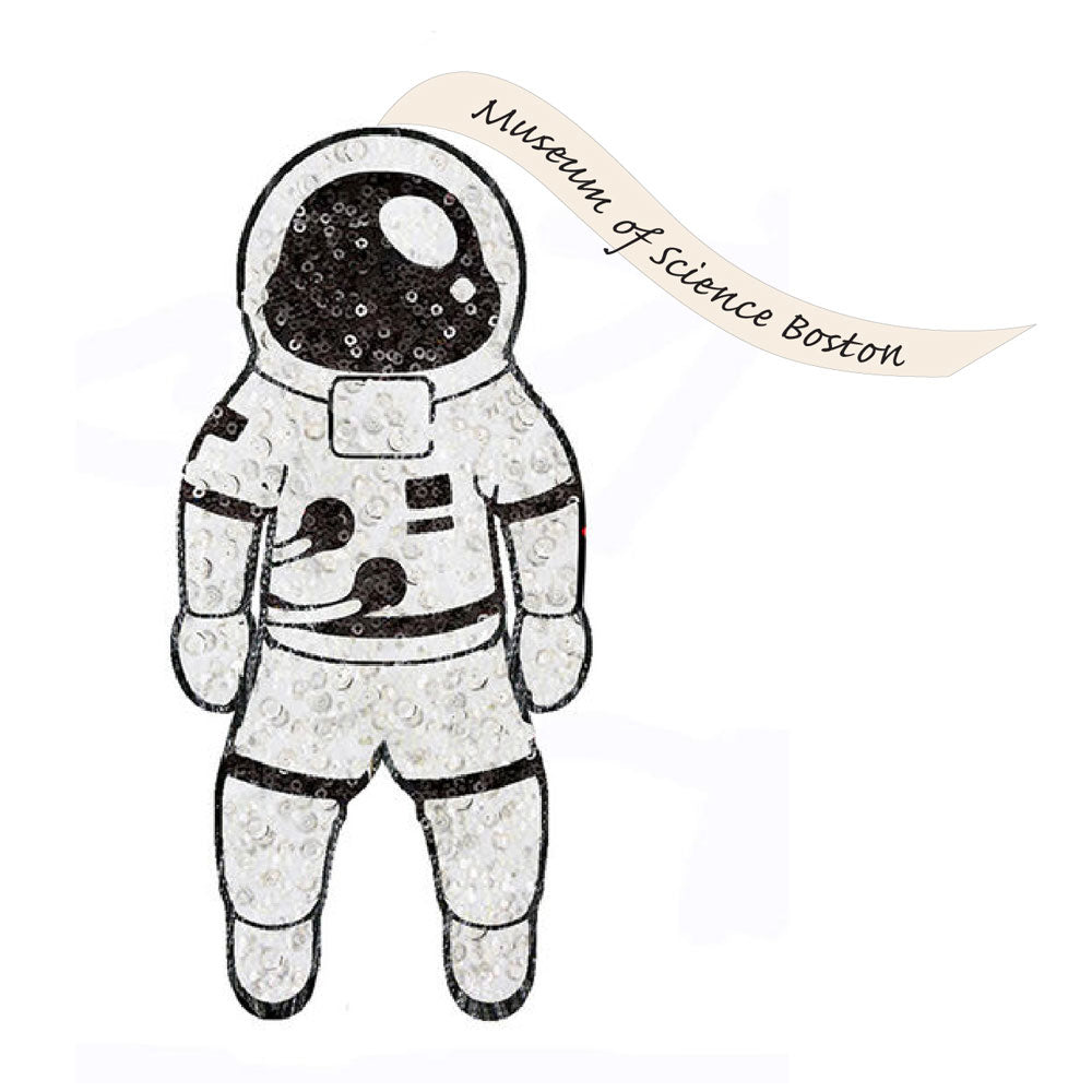 A black-outlined illustration of the Museum of Science Boston Sequin Astronaut Ornament features a sparkly texture, with a wavy banner above reading “Museum of Science Boston” to celebrate space exploration.