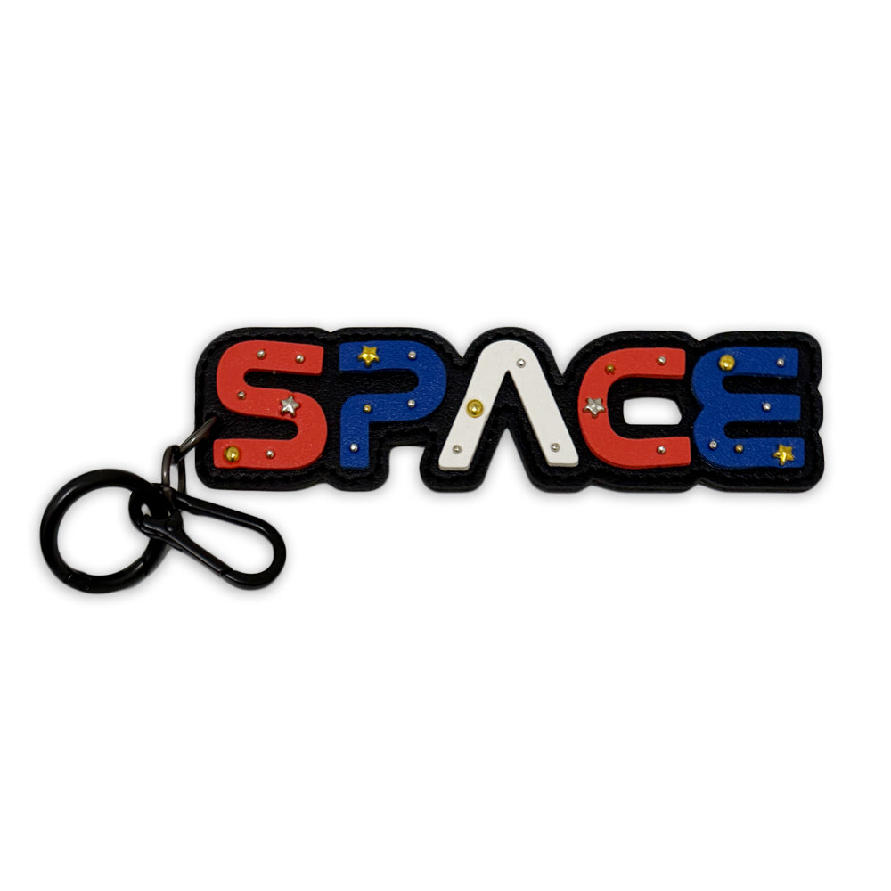 The Space Carabiner Bag Clip features a bold "SPACE" keychain—S and E in red, P and C in blue, A in white—with small star accents, making it ideal for space fans or stargazers.