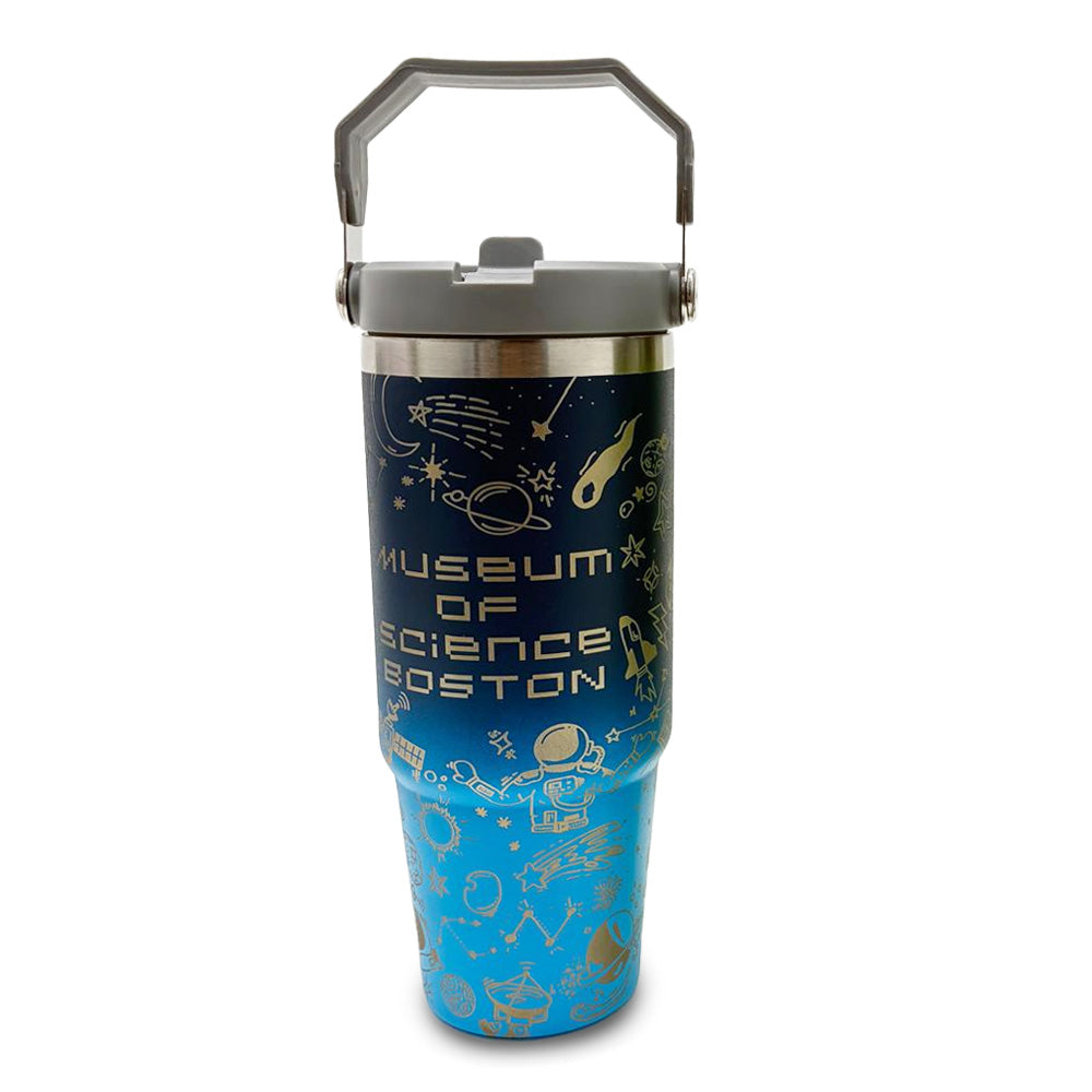 The Museum of Science Boston Science Flip Top Tumbler is blue with a gray handle, white science-themed illustrations, and "Museum of Science Boston" printed on the front.