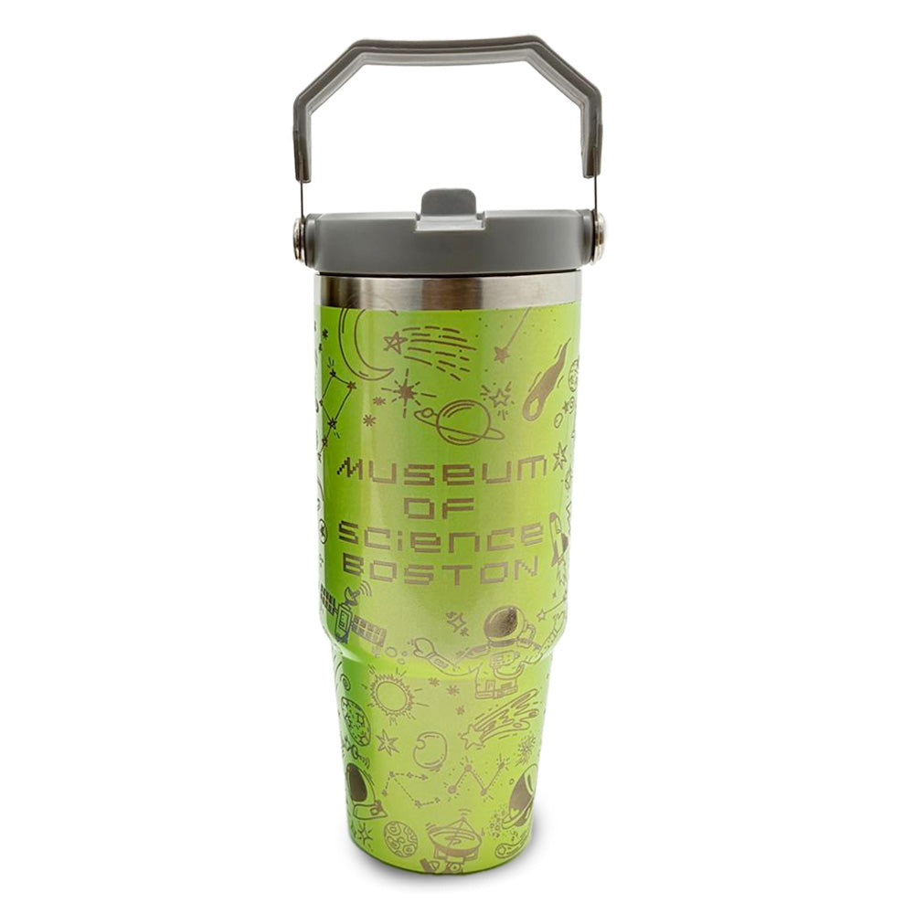 The Museum of Science Boston Science Flip Top Tumbler is tall and green, featuring a gray handle and lid, science-themed doodles, and the Museum of Science Boston logo printed on the front.