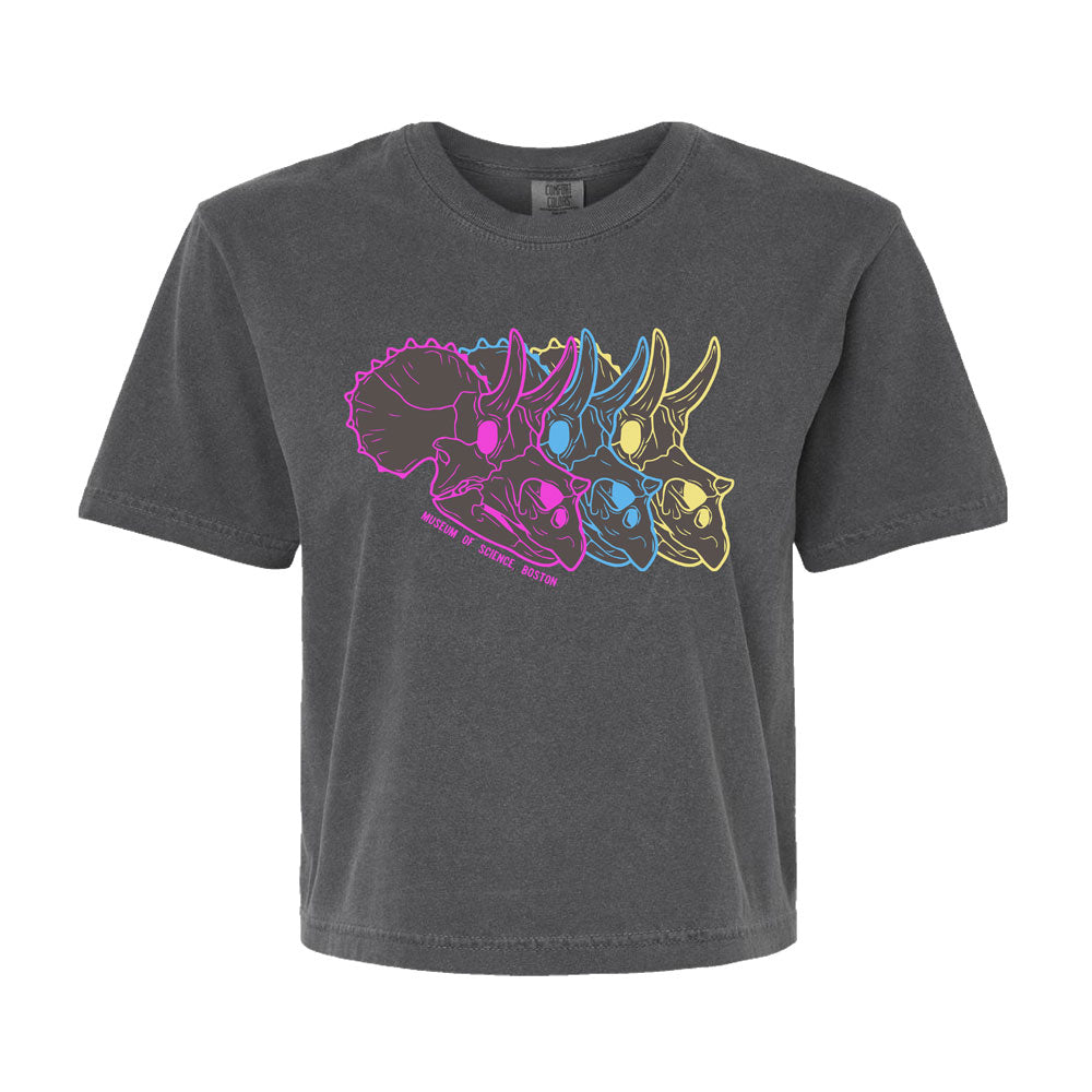 Introducing the Museum of Science Boston Cliff the Dino Boxy T-Shirt—a black science-themed tee featuring three overlapping triceratops skull outlines in vibrant pink, blue, and yellow. Displaying the “March of Science 2023” text and inspired by the Museum of Science Boston, this boxy t-shirt seamlessly combines bold style with a spirit of curiosity.