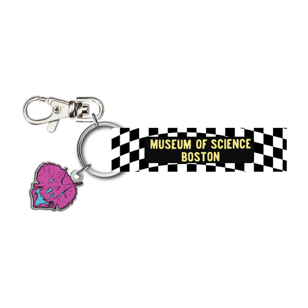 Museum of Science Boston Checkered Cliff the Dino Keychain—a quirky accessory featuring a black-and-white checkered tag with “Museum of Science Boston” in yellow lettering and a pink brain-shaped charm, perfect for fans of the Museum or anyone wanting to add a unique touch to their collection.