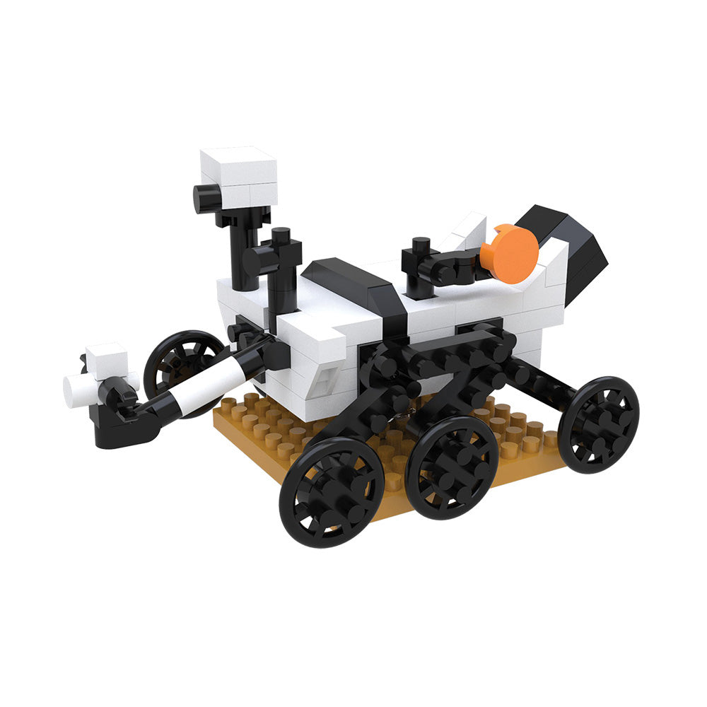 Introducing the Space Mystery Mini Blocks set—a small model rover constructed from LEGO-style bricks, featuring black wheels, a white and black body with an orange detail, and a camera mast. Displayed on a tan base, this collectible rover is perfect for building problem-solving skills and sparking curiosity about space exploration.